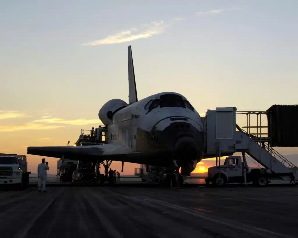 Space shuttle STS-114 landed at sunset, precision hydraulic lift systems technology.